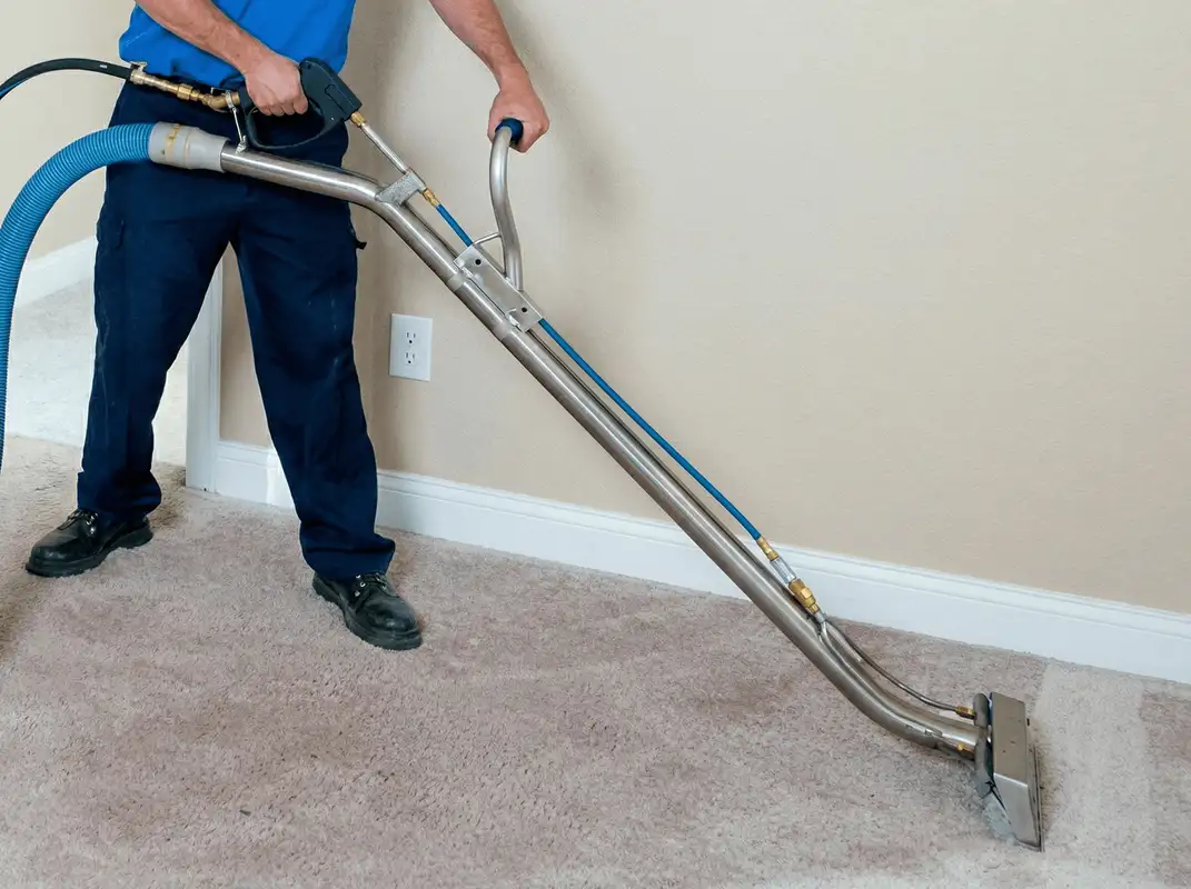 Professional operating a liquid removal machine on a carpeted floor in Chula Vista, CA