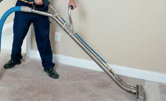 Professional operating a liquid removal machine on a carpeted floor in Chula Vista, CA